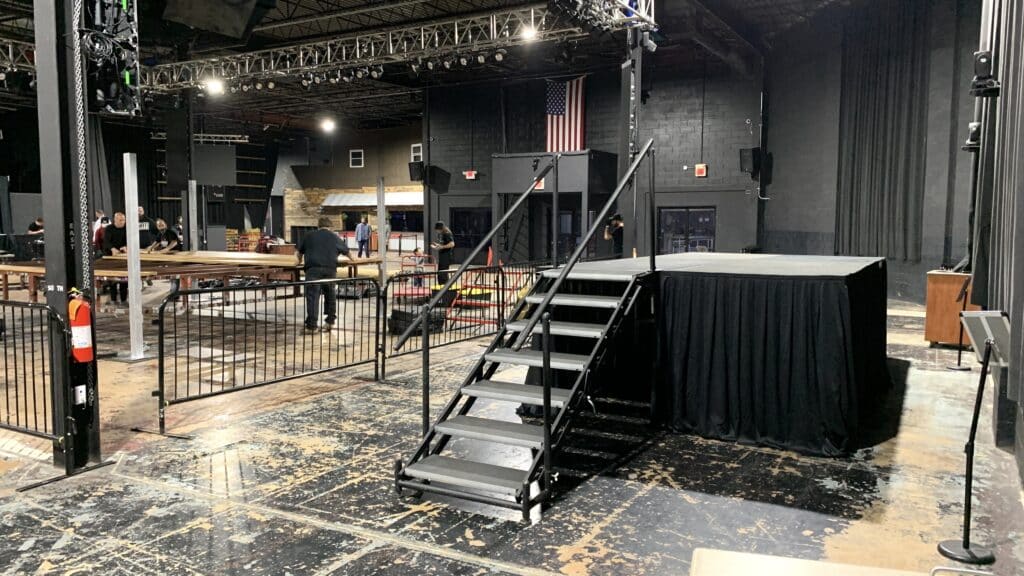 stage, stage platform, platform, staging, performance stage, camera riser, stage steps, black skirt, stage skirt, boxing ring